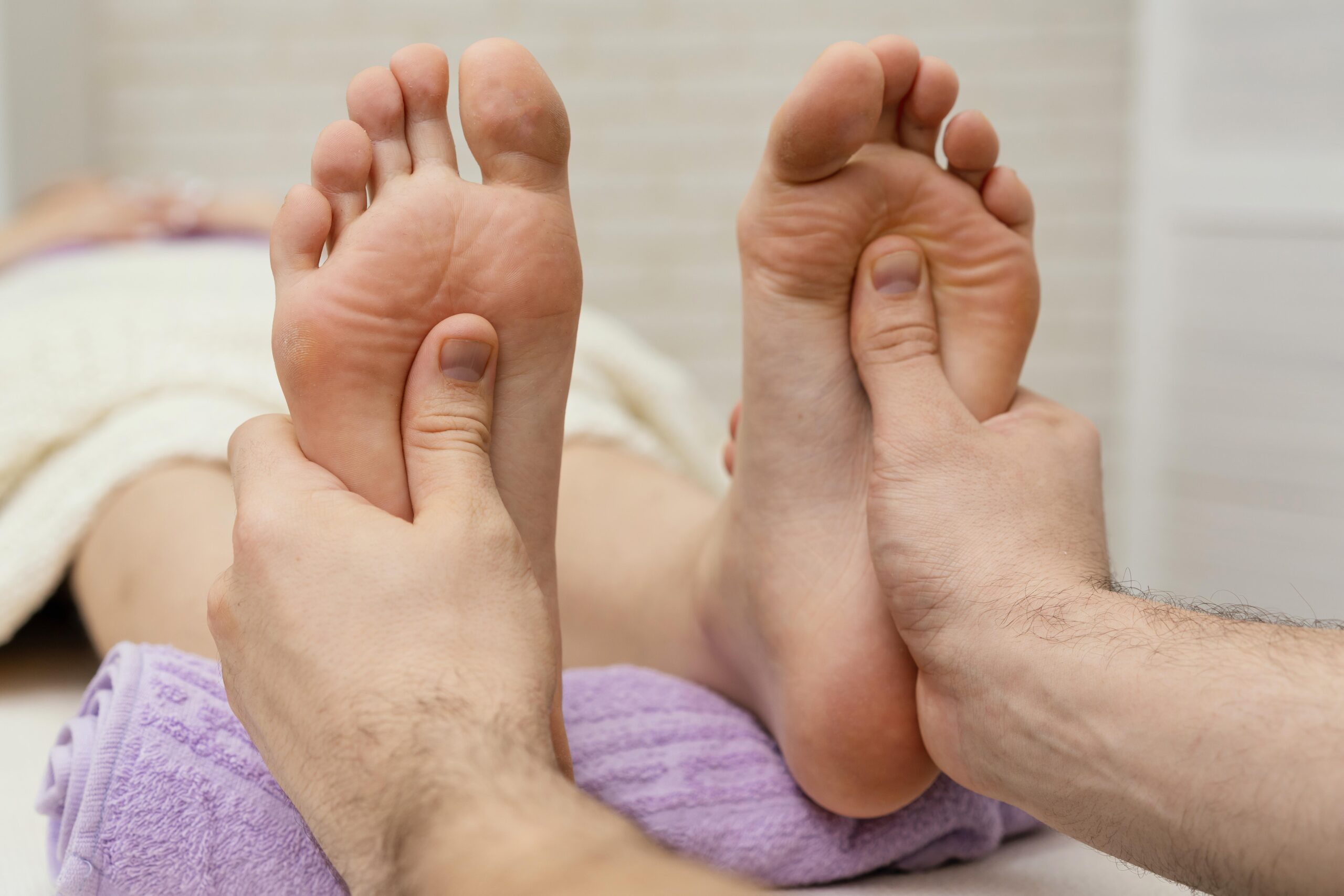 close up hands massaging soles